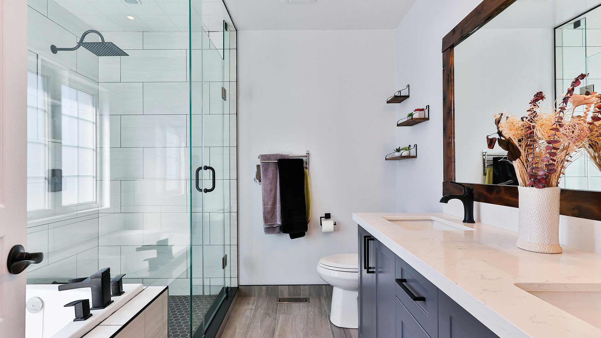 Bathroom remodel with glass shower enclosure and custom vanity